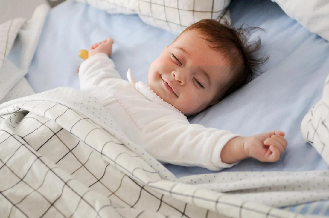 Newborn baby sleeping safely on back in crib with proper infant sleeping position, showing best practices for newborn sleep posture.