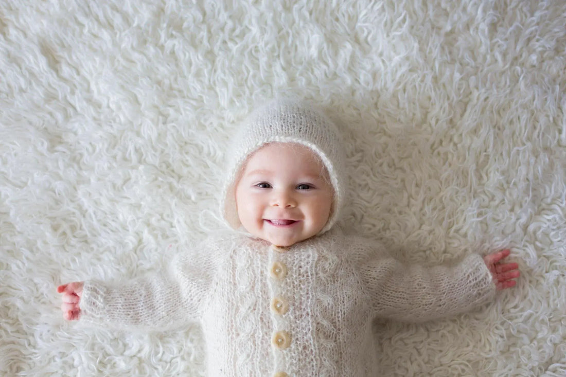 Happy baby in warm winter clothes with mother, showing tips for baby winter care and keeping infants healthy in cold weather.