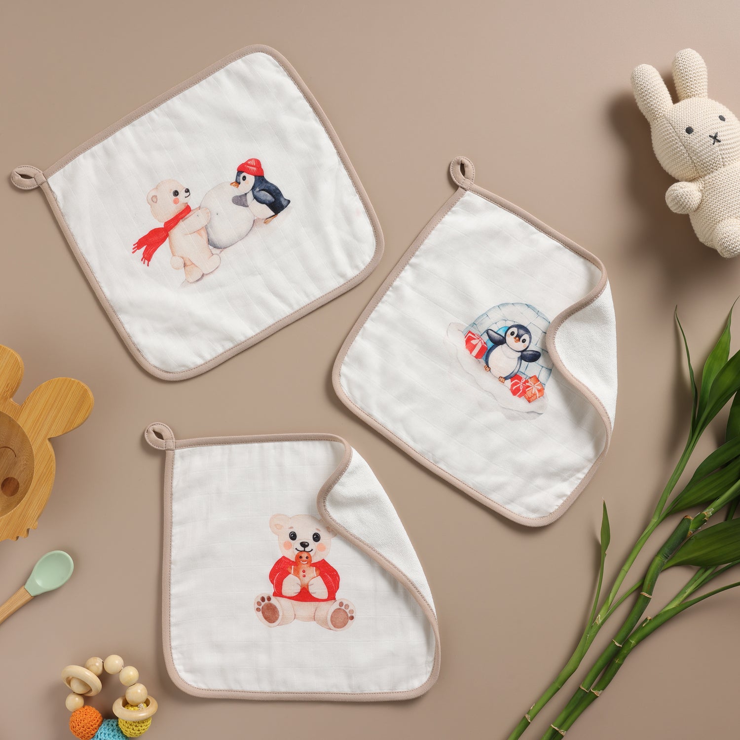 Set of three embroidered towels with animal designs on a beige background. 